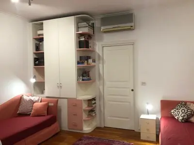 a living room with a couch and a white door at Camera Trastevere 2 in Rome
