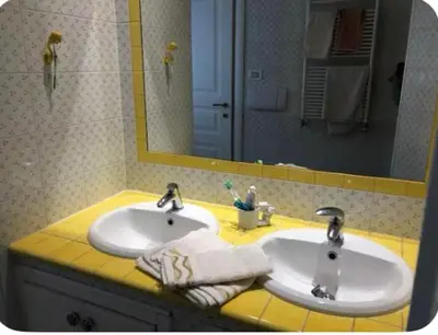 a bathroom with two sinks and a mirror at Camera Trastevere 2 in Rome