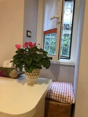 a vase with flowers on a counter in a kitchen at Camera Trastevere 2 in Rome