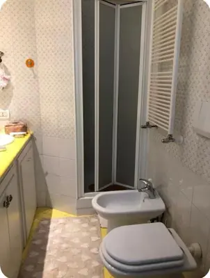 a bathroom with a toilet and a shower and a sink at Camera Trastevere 2 in Rome