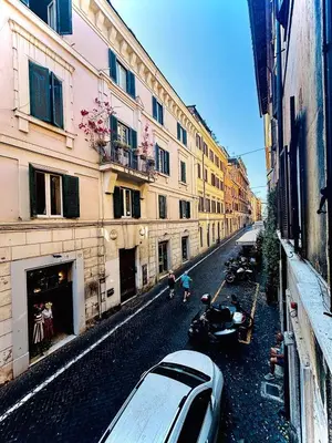 a street with buildings and a car parked on the street at Monti Hideaway - Walk to Colosseum & Forum in Rome