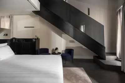a bedroom with a bed and a black staircase at Casa Guttmann in Rome