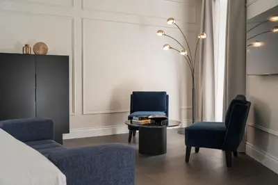 a bedroom with two chairs and a table and a bed at Casa Guttmann in Rome