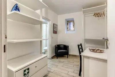 a kitchen with a counter and a chair in a room at Petite Fleur in Rome