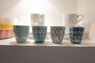 four blue and white cups sitting on a shelf at Elegant Design Retreat by Campo de Fiori in Rome