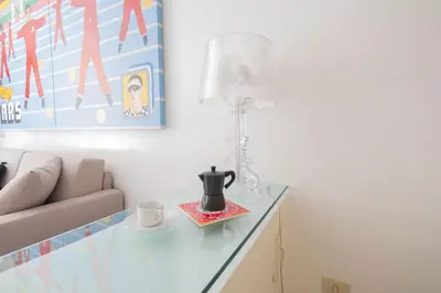 a room with a glass table with a lamp and a couch at Elegant Design Retreat by Campo de Fiori in Rome