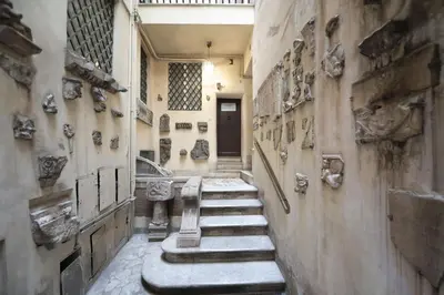 a hallway in a museum with statues on the wall at Elegant Design Retreat by Campo de Fiori in Rome