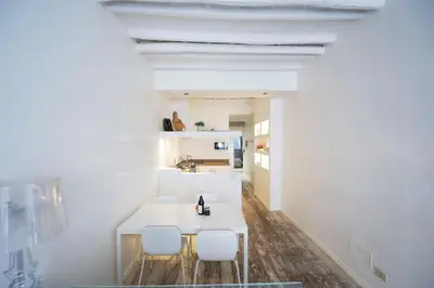 a dining room with a white table and chairs at Elegant Design Retreat by Campo de Fiori in Rome