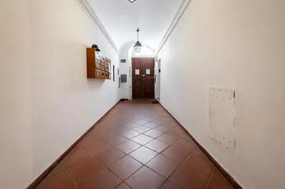 a hallway with a door and a tiled floor at Skylife Monti's Wonders - Colosseum Gem in Rome