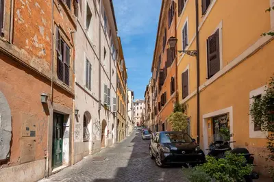 a car parked on a street between two buildings at Skylife Monti's Wonders - Colosseum Gem in Rome