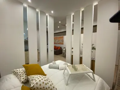 a living room with a white couch and a table at Loft in the Ghetto 2 in Rome