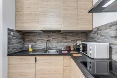 a kitchen with a sink and a microwave at Loft in the Ghetto 2 in Rome