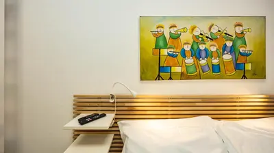 a bedroom with a painting of a group of people at Flat 5 - In San Giovanni by Rentbeat in Rome