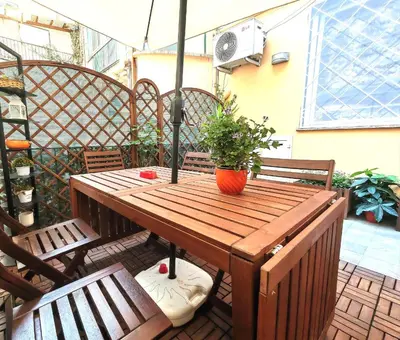 a wooden table with a potted plant on a patio at Piramide Charming Flat e Terrace in Rome