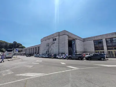 a large building with cars parked in front of it at Piramide Charming Flat e Terrace in Rome