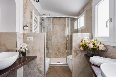 a bathroom with a shower and a sink at Domus Gabriella - Roman Forum Apartment in Rome