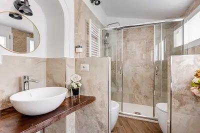 a bathroom with a sink and a shower at Domus Gabriella - Roman Forum Apartment in Rome