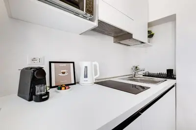 a kitchen counter with a coffee maker and a microwave at Domus Gabriella - Roman Forum Apartment in Rome
