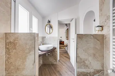 a bathroom with a sink and a mirror at Domus Gabriella - Roman Forum Apartment in Rome