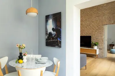 a dining room with a table and a tv at Colosseum - Diana's Design Apartment in Rome