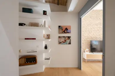 a living room with white walls and a fireplace at Colosseum - Diana's Design Apartment in Rome