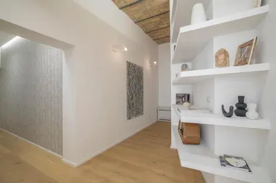 a hallway with white walls and white shelves at Colosseum - Diana's Design Apartment in Rome