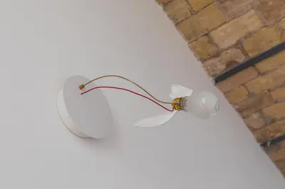 a white light attached to a wall at Colosseum - Diana's Design Apartment in Rome