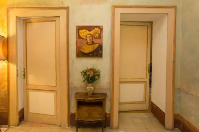 a hallway with two doors and a vase of flowers on a table at Domus Picta Roomy Apartment in Rome