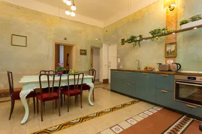 a kitchen with a table and chairs in a room at Domus Picta Roomy Apartment in Rome
