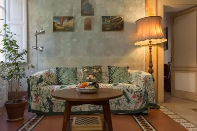 a living room with a couch and a table at Domus Picta Roomy Apartment in Rome