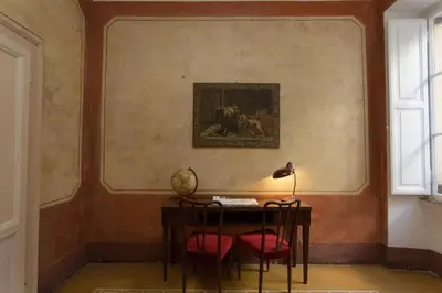 a room with a desk and a painting on the wall at Domus Picta Roomy Apartment in Rome
