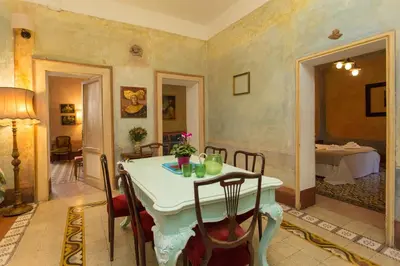 a dining room with a white table and chairs at Domus Picta Roomy Apartment in Rome