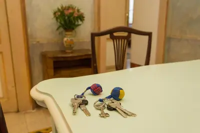 two pairs of keys sitting on top of a table at Domus Picta Roomy Apartment in Rome