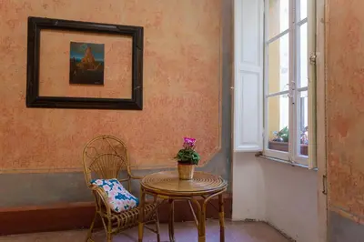 a table and two chairs in a room at Domus Picta Roomy Apartment in Rome