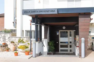 a building with a sign that reads villa santaanzalezlezarma at Villa Santa Emerenziana in Rome