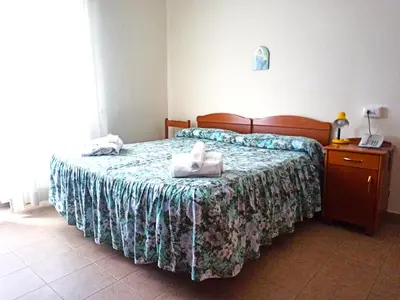 a bedroom with a bed with towels on it at Villa Santa Emerenziana in Rome