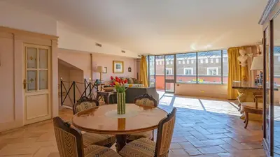 a living room with a table and chairs at EasyTopStay - Charme and View in the Heart of Rome in Rome