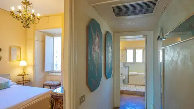 a bedroom with a bed and a bathroom at EasyTopStay - Charme and View in the Heart of Rome in Rome