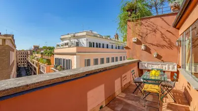 a balcony with a table and chairs on a building at EasyTopStay - Charme and View in the Heart of Rome in Rome