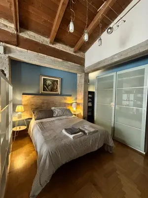 a bedroom with a large bed and a blue wall at Monolocale Centro Stazione Tiburtina in Rome