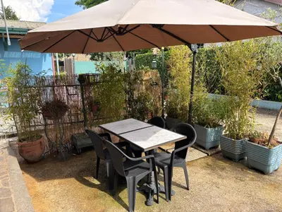 a wooden table and chairs under an umbrella at Monolocale Centro Stazione Tiburtina in Rome