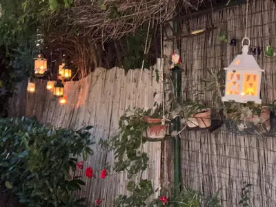a garden with a lantern hanging on a fence at Monolocale Centro Stazione Tiburtina in Rome