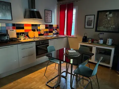 a kitchen with a table and chairs in a kitchen at Monolocale Centro Stazione Tiburtina in Rome