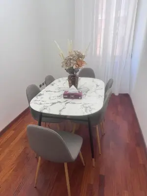 a table with a vase on top of it with chairs at 3 coins trastevere station in Rome