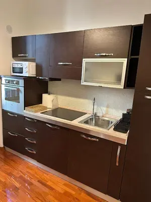 a kitchen with a sink and a microwave at 3 coins trastevere station in Rome
