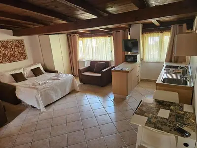 a large living room with a bed and a couch at Monolocale loft ristrutturato- Metro Manzoni in Rome