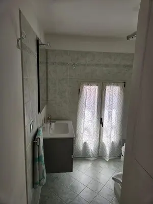 a bathroom with a sink and a tub and a window at Monolocale loft ristrutturato- Metro Manzoni in Rome