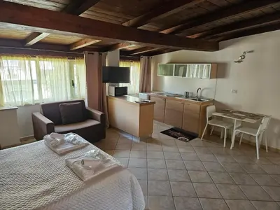 a bedroom with a bed and a kitchen with a table at Monolocale loft ristrutturato- Metro Manzoni in Rome