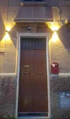 a building with a brown door with lights on it at Monolocale loft ristrutturato- Metro Manzoni in Rome