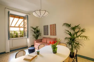 a living room with a table and a couch at Daplace - Serena Apartment in Rome